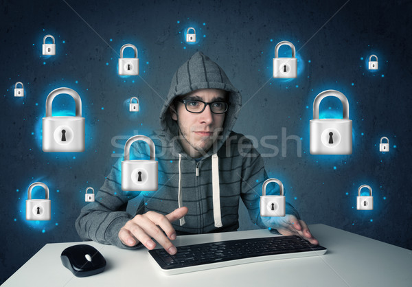 Young hacker with virtual lock symbols and icons Stock photo © ra2studio