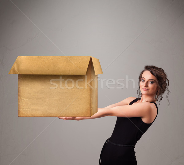 Young woman holding an empty cardboard box Stock photo © ra2studio