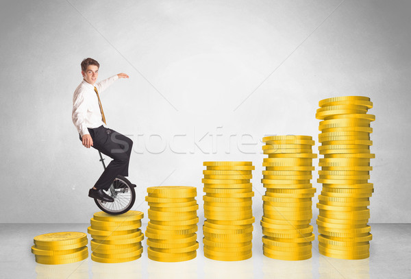 Business man riding monocycle up on coin graph Stock photo © ra2studio