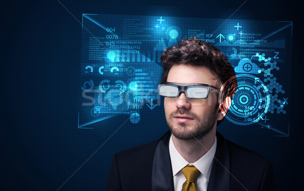 Young man looking with futuristic smart high tech glasses  Stock photo © ra2studio