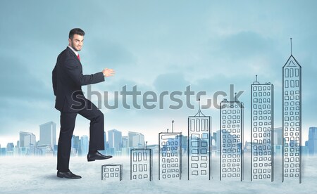 Business man climbing up on hand drawn buildings in city Stock photo © ra2studio