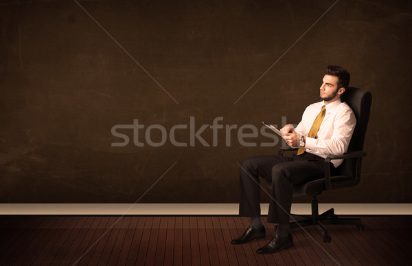Businessman holding high tech tablet on background with copyspac Stock photo © ra2studio