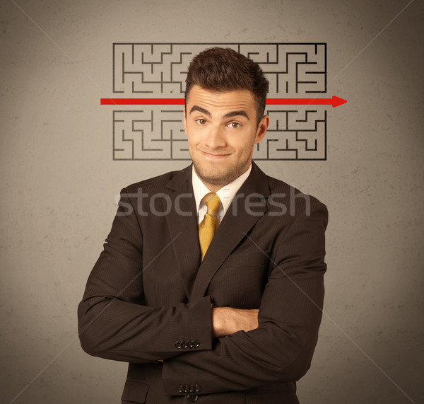 Handsome business guy solving maze Stock photo © ra2studio