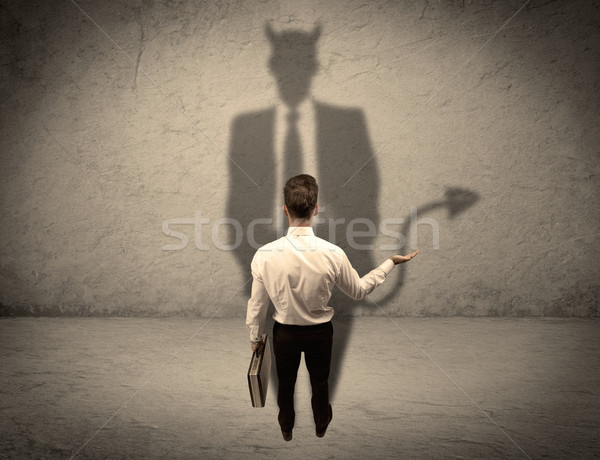 Salesman facing his own devil shadow Stock photo © ra2studio