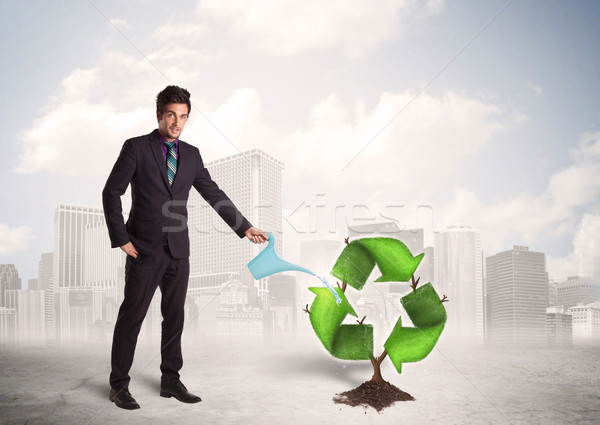 Business man watering green recycle sign tree on city background Stock photo © ra2studio