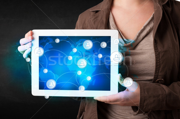 Young person holding talbet with communication technology concep Stock photo © ra2studio