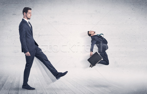 Big man kicking small man with grungy background Stock photo © ra2studio