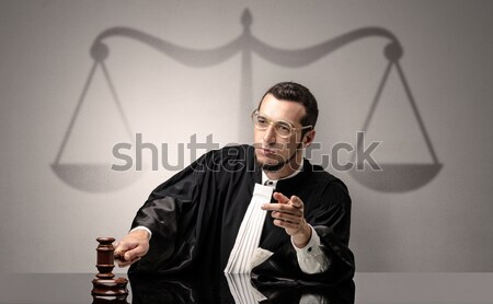 Young judge in gown deciding Stock photo © ra2studio