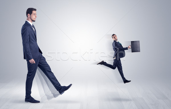 Stock photo: Giant businessman kicking out little businessman 