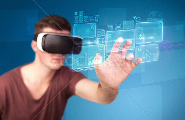 Man wearing virtual reality goggles Stock photo © ra2studio
