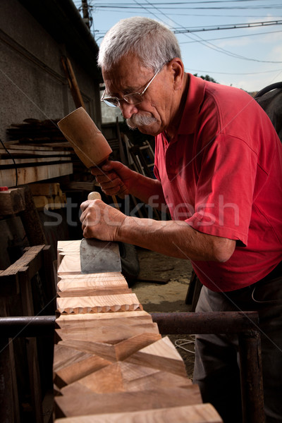 Old woodcarver working with mallet Stock photo © ra2studio