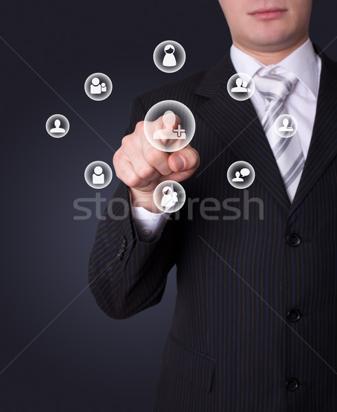 Man pressing social network button Stock photo © ra2studio