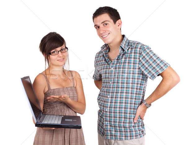 A welldressed young couple holding a laptop and smiling Stock photo © ra2studio