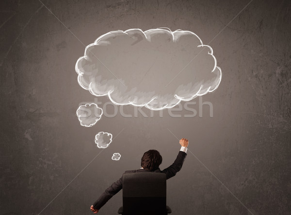 Businessman sitting with cloud thought above his head Stock photo © ra2studio