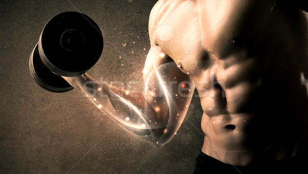 Stock photo: Bodybuilder lifting weight with energetic white lines concept