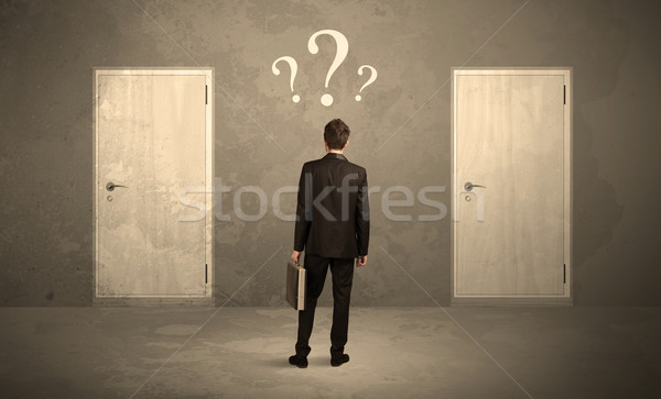 Businessman standing in front of doors Stock photo © ra2studio