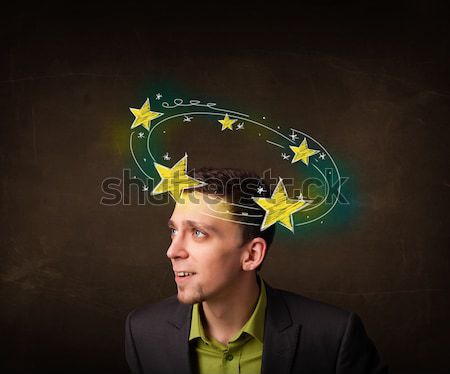 Young man with yellow stars circleing around his head Stock photo © ra2studio