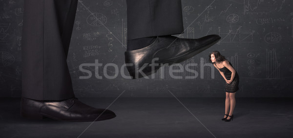 Huge leg stepping on a tiny businnesswoman concept Stock photo © ra2studio