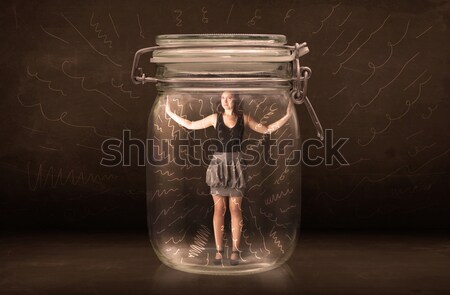 Businesswoman inside a jar with powerful hand drawn lines concep Stock photo © ra2studio