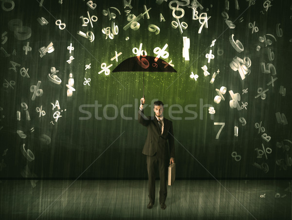 Businessman standing with umbrella and 3d numbers raining concep Stock photo © ra2studio