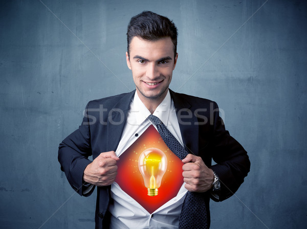 Businessman ripping off shirt and idea light bulb appears  Stock photo © ra2studio