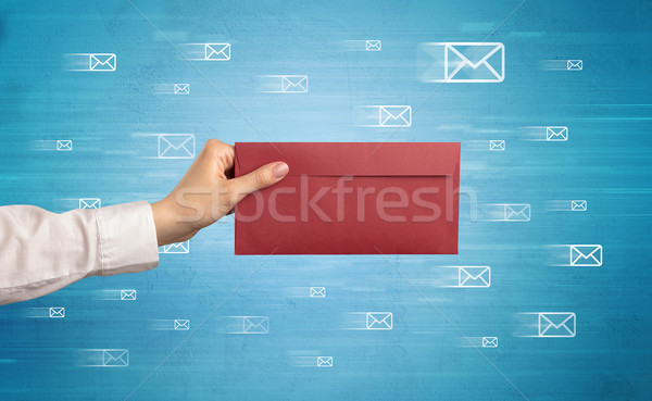 Hand holding envelope with message symbols around Stock photo © ra2studio
