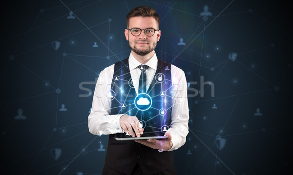 Secured cloud concept with businessman and tablet Stock photo © ra2studio