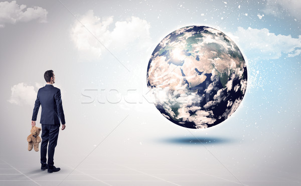 Człowiek patrząc ziemi świecie uprzejmość biznesmen Zdjęcia stock © ra2studio