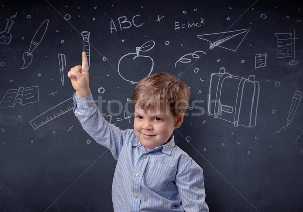 Little boy in front of a drawn up blackboard Stock photo © ra2studio