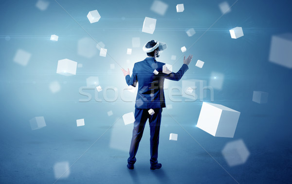Businessman with vr goggle and falling cubes Stock photo © ra2studio