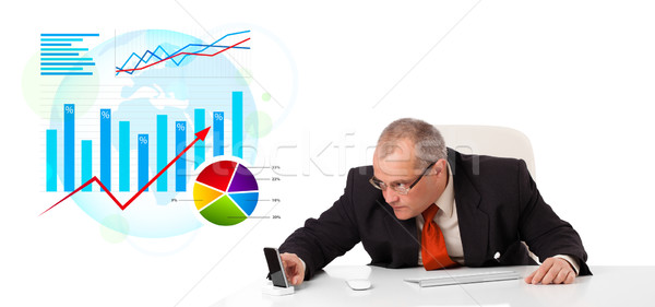 Businessman sitting at desk with statistics Stock photo © ra2studio