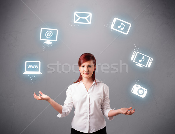 pretty girl juggling with elecrtonic devices icons Stock photo © ra2studio