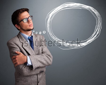 Good-looking young man thinking about speech or thought bubble Stock photo © ra2studio
