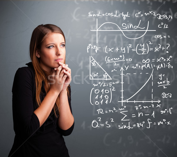 Stock photo: Beautiful school girl thinking about complex mathematical signs