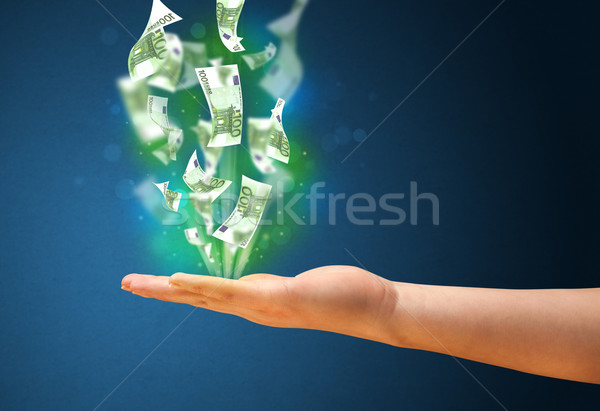 Stock photo: Glowing money in the hand of a woman