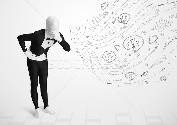 Guy in body suit morphsuit looking at sketches and doodles Stock photo © ra2studio