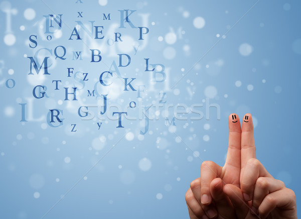 Stock photo: Happy smiley fingers looking at mixture of bokeh letters