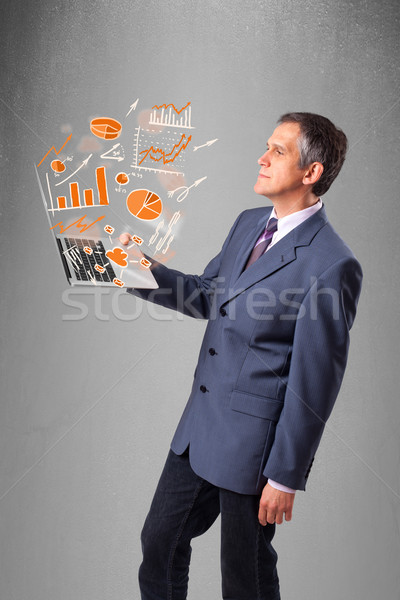 Businessman holding notebook with graphs and statistics Stock photo © ra2studio