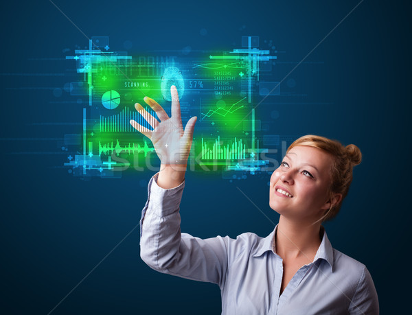 Young businesswoman pressing modern technology panel with finger Stock photo © ra2studio