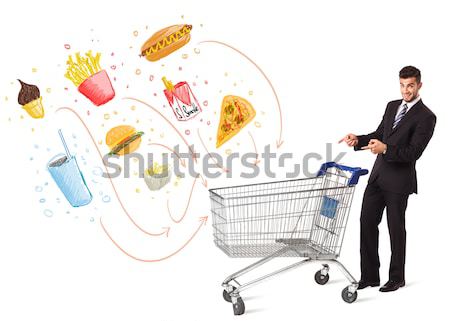 Stock photo: Man with shopping cart with toxic junk food