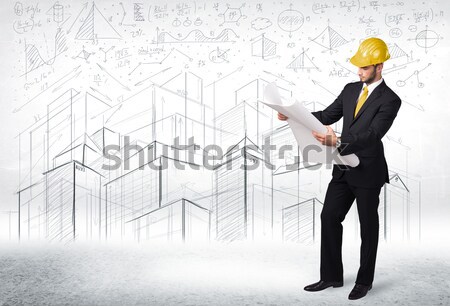 Handsome construction specialist with city drawing in background Stock photo © ra2studio