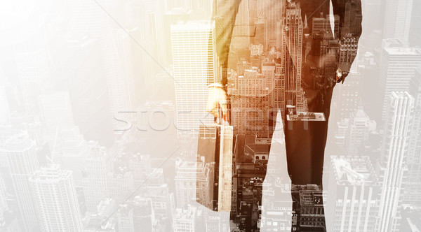 Business person with warm color overlay of city background Stock photo © ra2studio