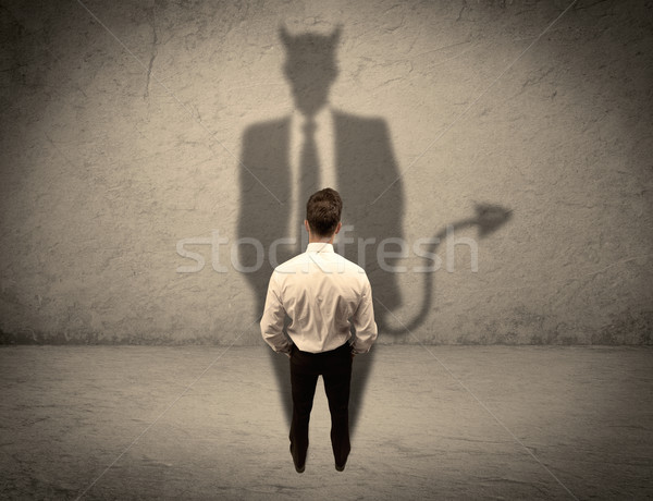 Salesman facing his own devil shadow Stock photo © ra2studio