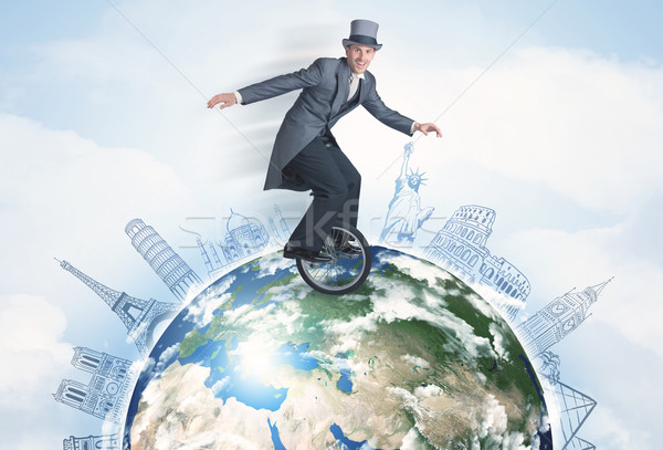 Man riding unicycle around the globe with major cities Stock photo © ra2studio