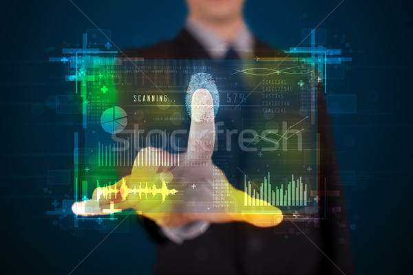 Young businessman pressing modern technology panel with finger p Stock photo © ra2studio