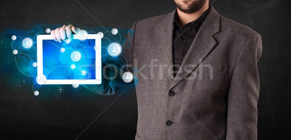 Young person holding talbet with communication technology concep Stock photo © ra2studio