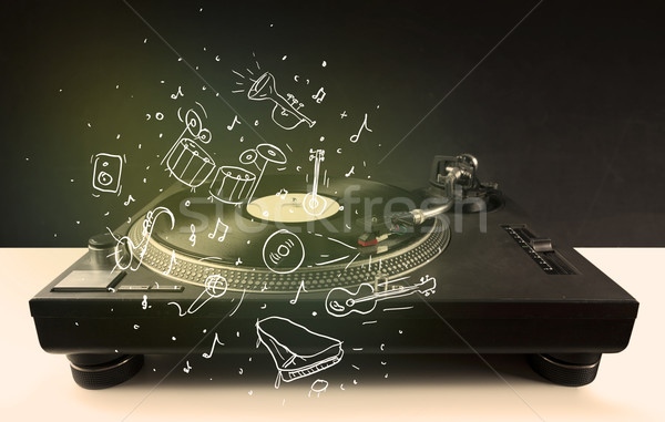 Stock photo: Turntable playing classical music with icon drawn instruments 