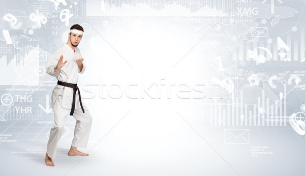 Karate man doing karate tricks on the top of a metropolitan city Stock photo © ra2studio