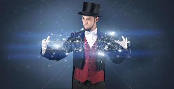 Magician with geometrical connection on his hand  Stock photo © ra2studio