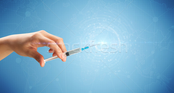 Female doctor holding syringe Stock photo © ra2studio
